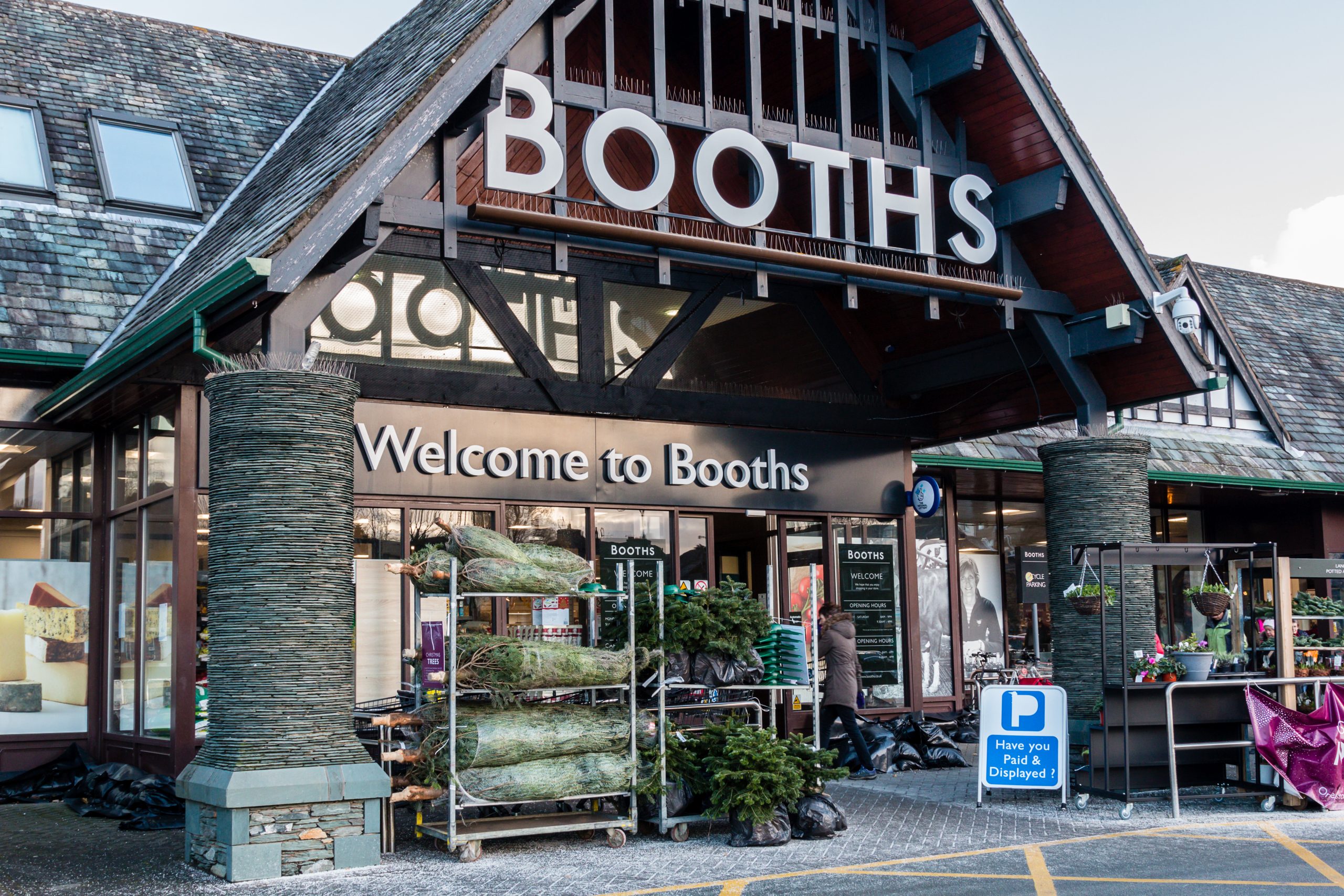 Booths drop annual profits