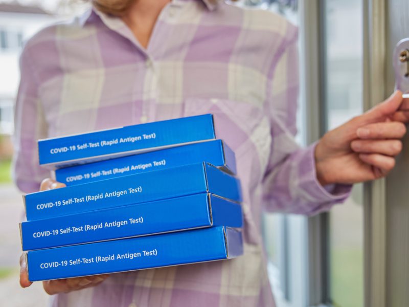 Close up of five lateral flow test kit boxes