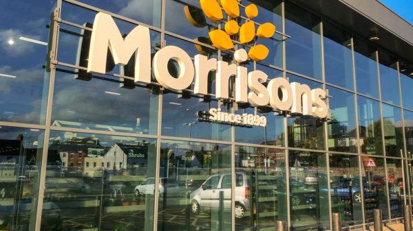 A glass exterior of a Morrisons supermarket store front.