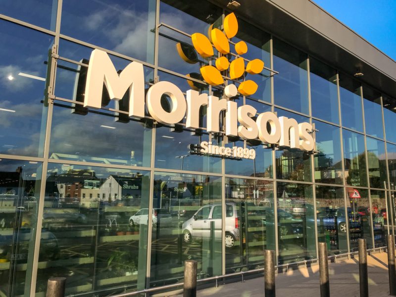 A glass exterior of a Morrisons supermarket store front.