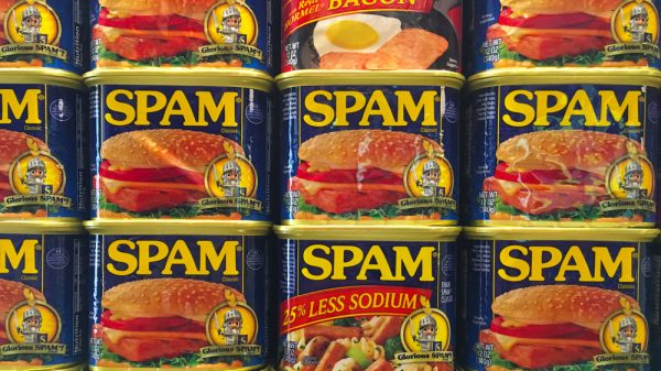Stacked tins of Spam on a supermarket shelf