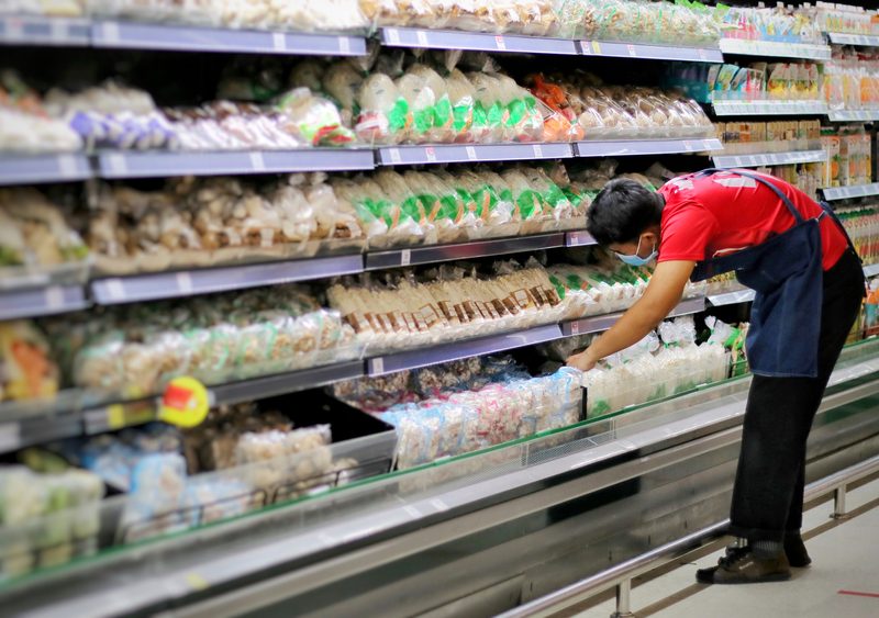 Supermarket worker stacking shelves