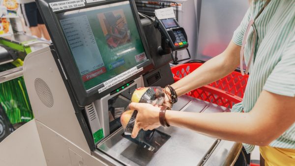 Woman scanning food at a self-checkout