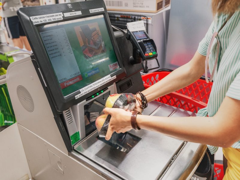 Woman scanning food at a self-checkout