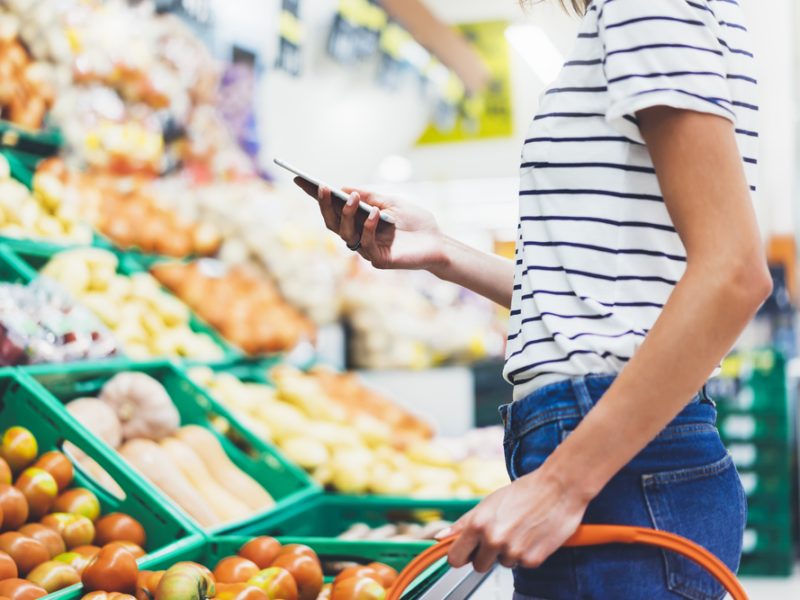 Woman in the fruit and veg aisle at the supermarket
