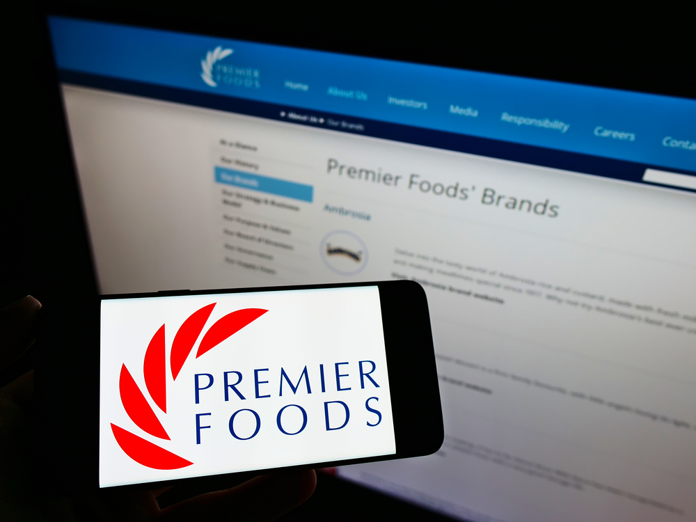 A phone showing Premier Foods logo infront of its website