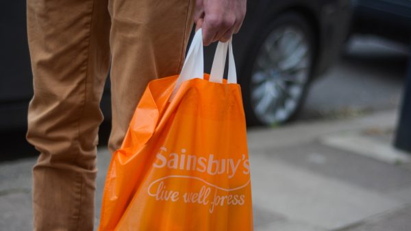 Man holding Sainsbury's shopping bag