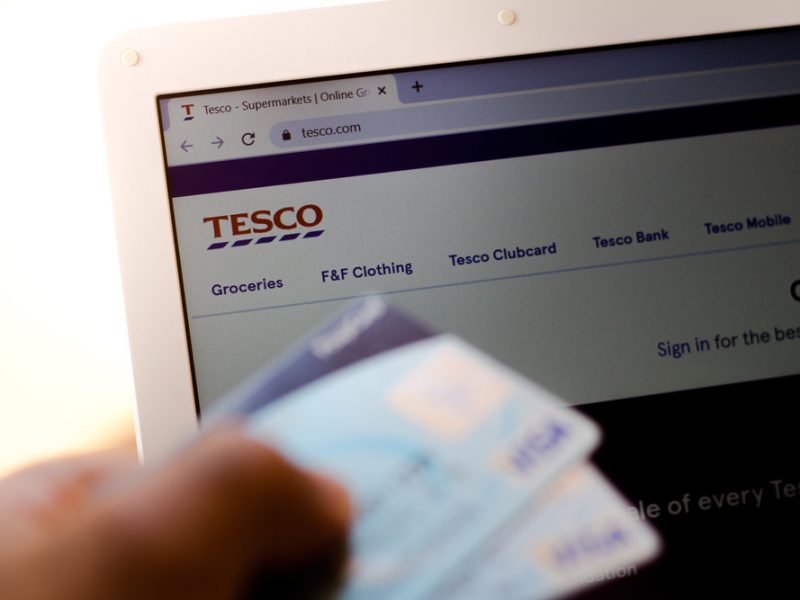 Tesco clubcard infront of a laptop showing Tesco's website