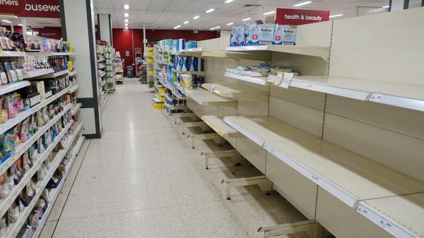 An empty health & beauty aisle in a UK supermarket.