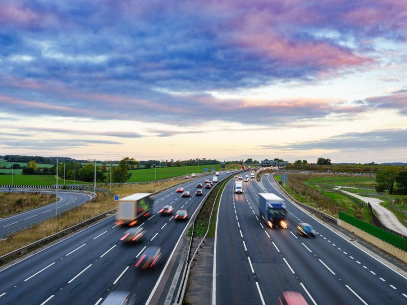 Lorries drive down a motorway.