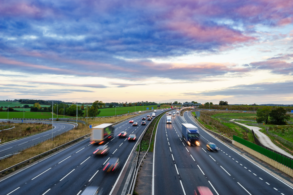 Lorries drive down a motorway.