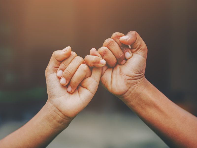 fingers linking as pledge