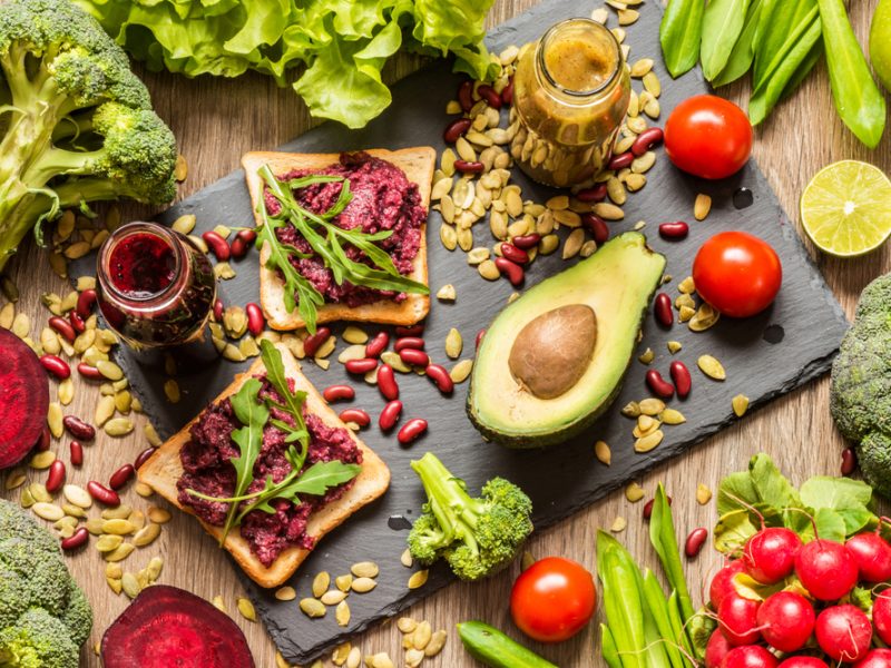 A chopping board full of fresh, vegan ingredients and produce.