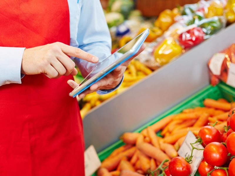Store manager doing warehouse management with tablet computer in a supermarket