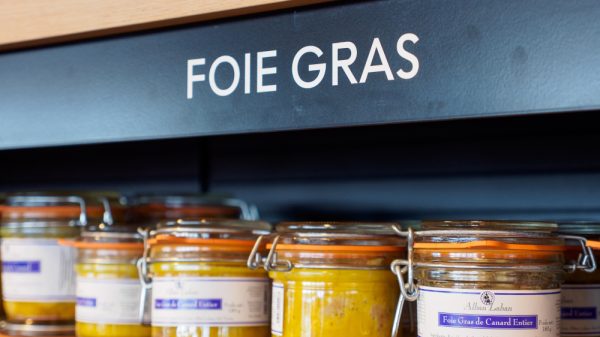 Jars of foie gras sit on a supermarket shelf.