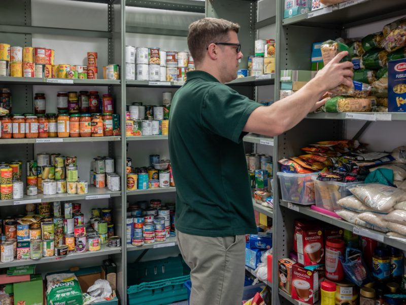 A person stocking donated food from supermarkets.