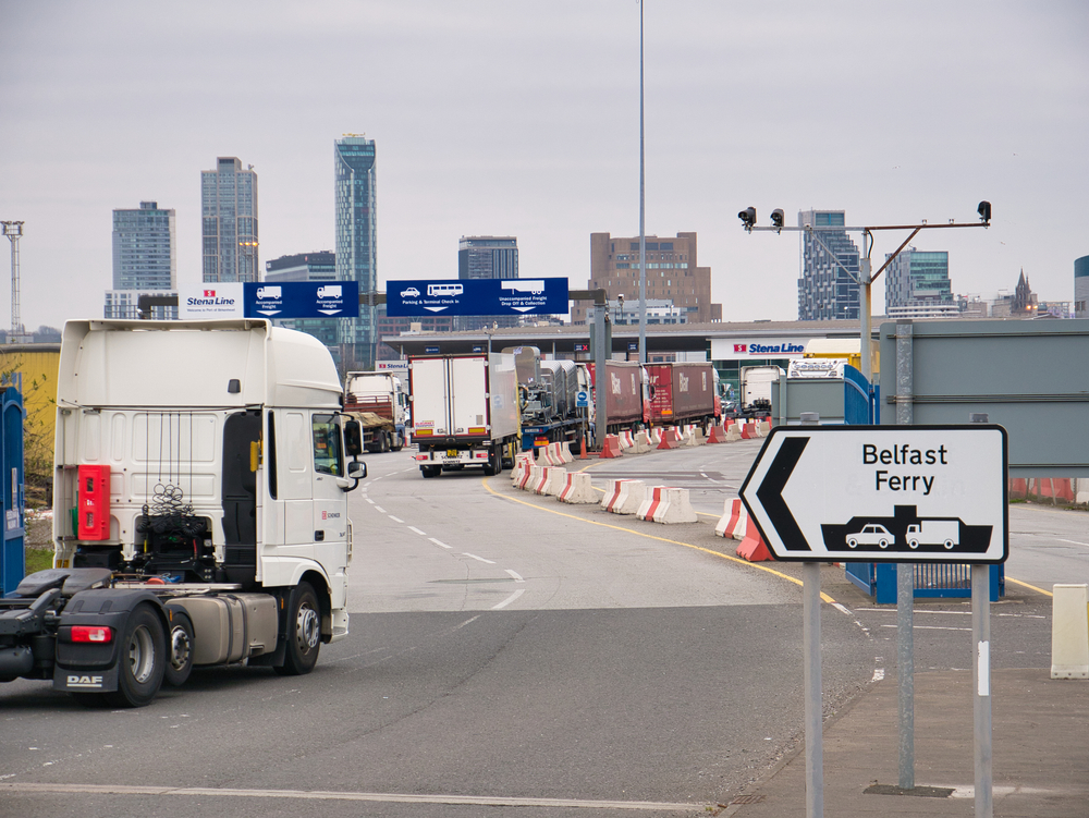 A lorry drives past a sign in Northern Ireland.