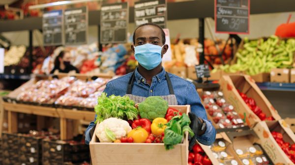 supermarket worker with covid mask