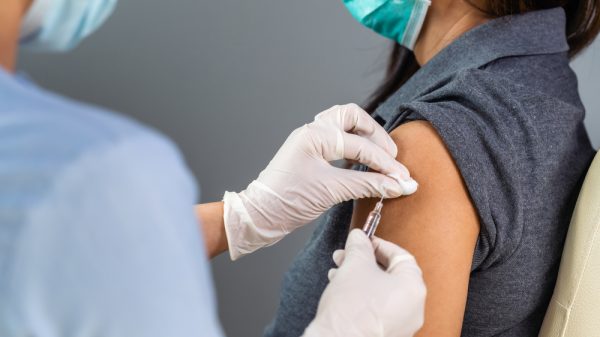 A healthcare worker administering a Covid-19 vaccine