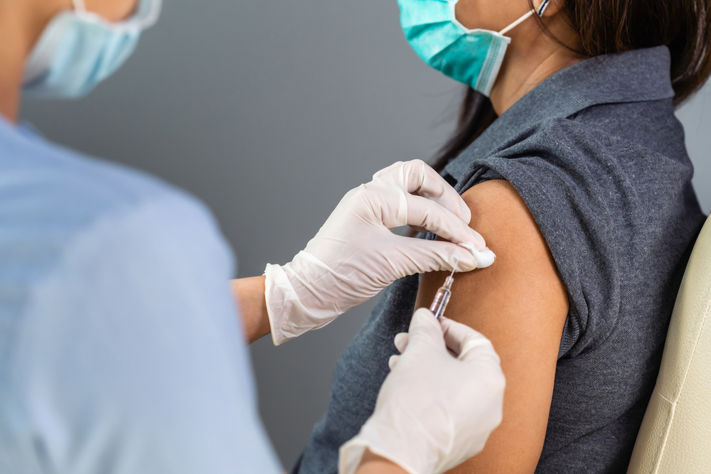 A healthcare worker administering a Covid-19 vaccine