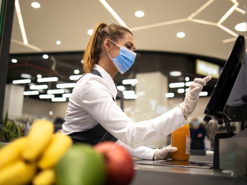 a supermarket worker at a till.