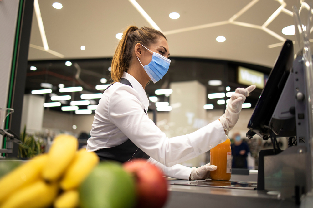 a supermarket worker at a till.