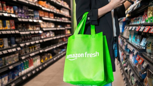 Customer shopping in Amazon Fresh with an Amazon Fresh bag