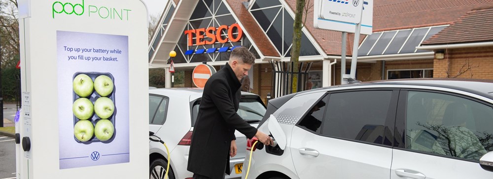 Customer using Tesco's free electric vehicle charger