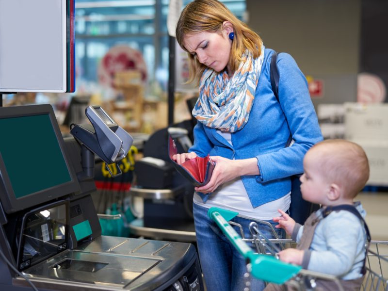 Customer checking wallet at checkout