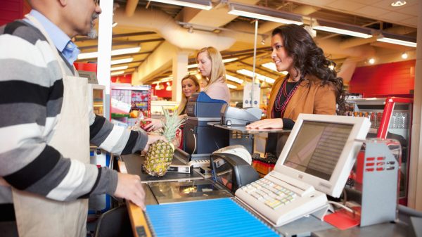 Grocery shopper at checkout purchasing food
