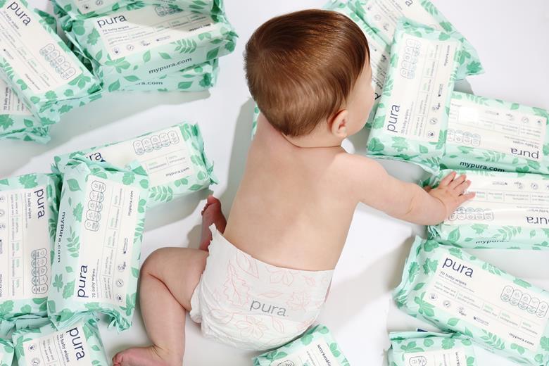 Baby surrounded by Pura baby wipes