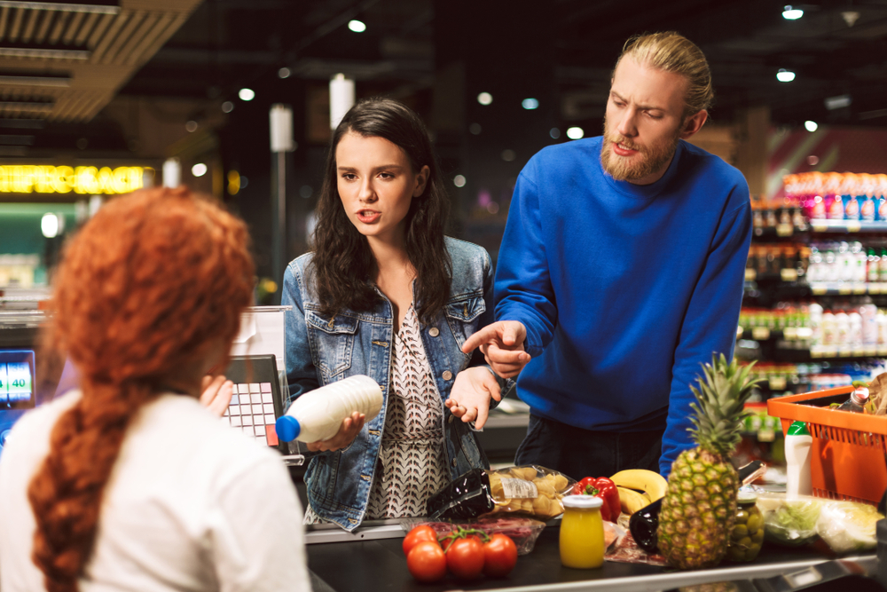customers arguing with an employee at checkout