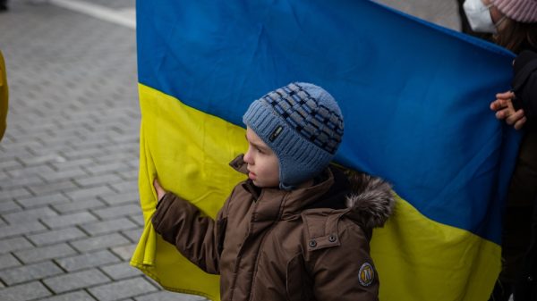 A child holds a Ukraine flag.