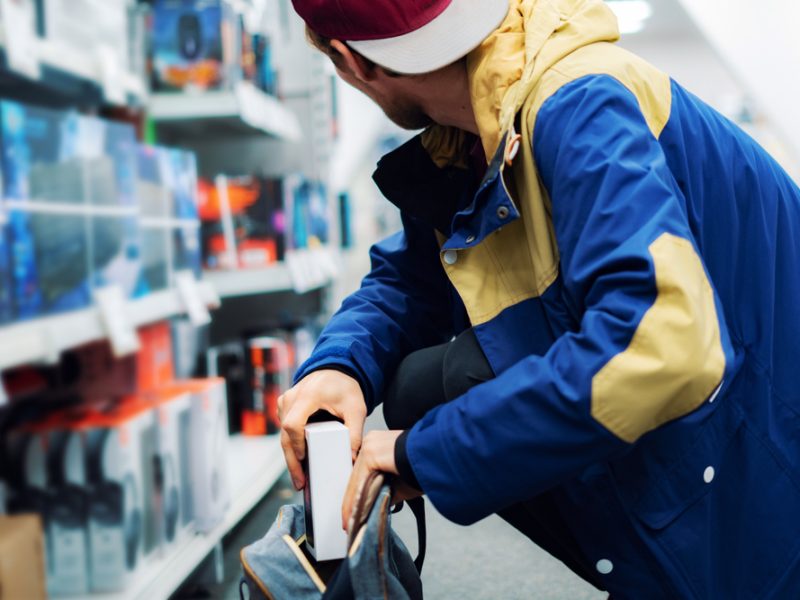 A person steals an item from a store.
