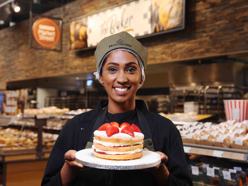Morrisons employee holding Queen's Jubilee cake