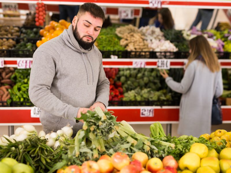 customer choosing vegetable within a supermarket