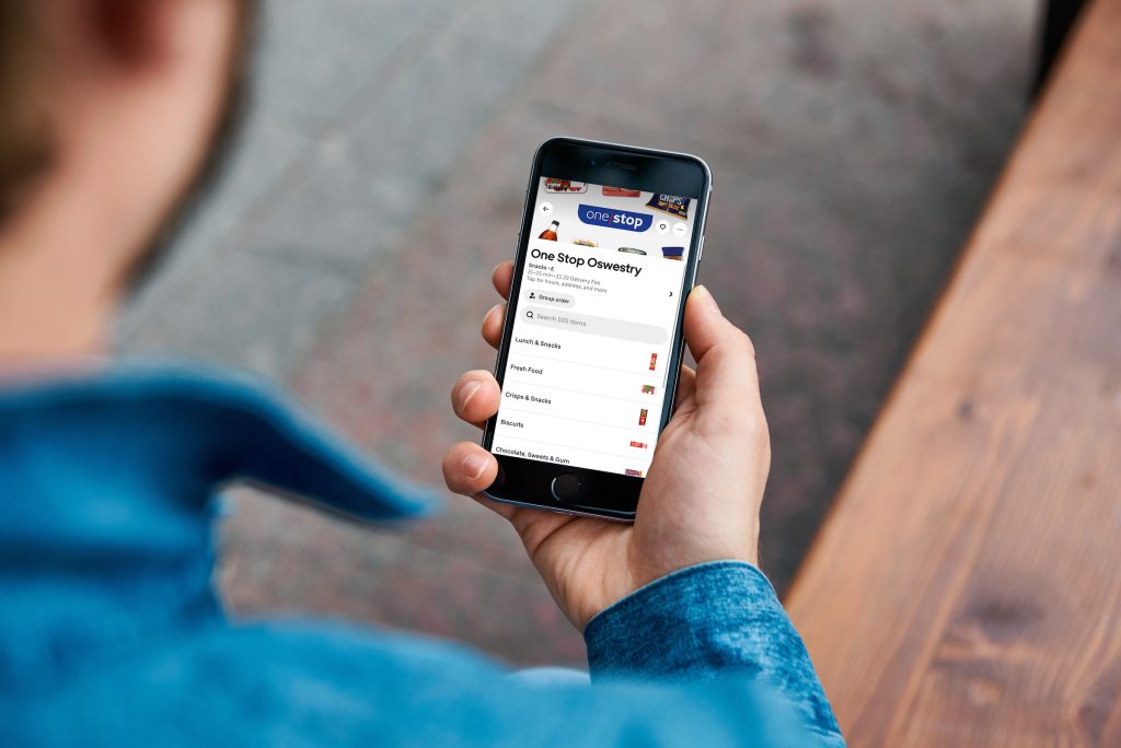 Close-up shot of a man ordering pizza with food delivery app