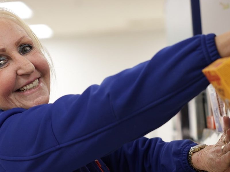 Tesco staff member stocking shelves