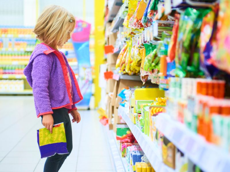 girl looking at HFSS sweets