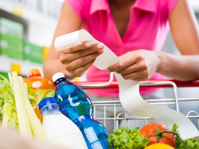A person looking through their shopping list.