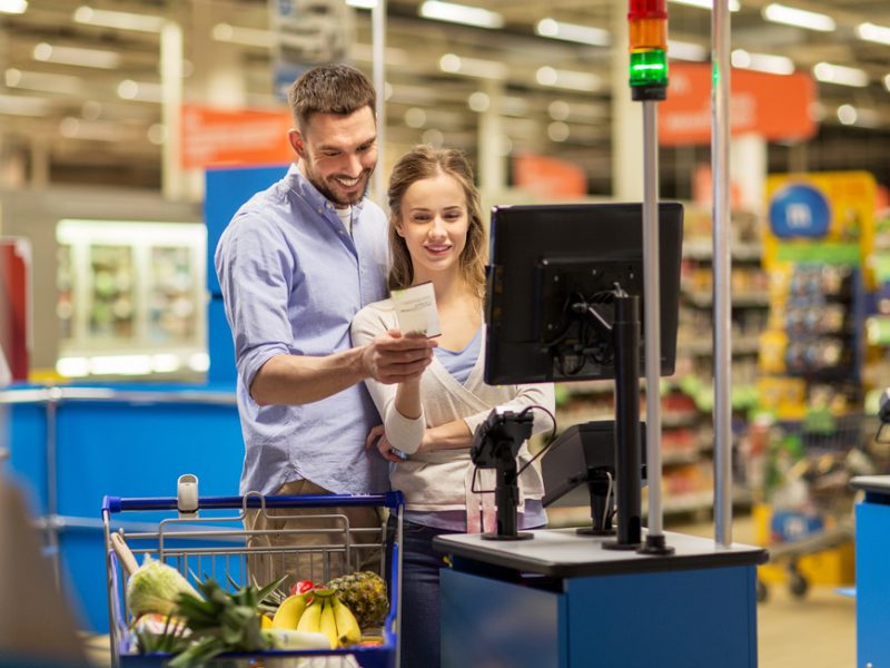 Customers at checkout using loyalty scheme to get a discount