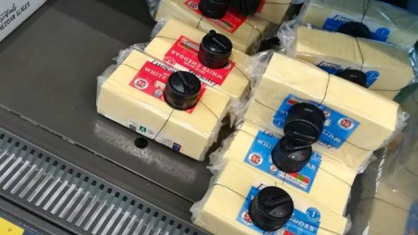 Cheese covered in security tags