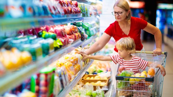 Parent and child in supermarket re changing shopping habits amid the cost-of-living crisis