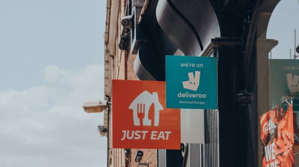 Deliveroo and Just Eat signs - re rapid grocery delivery dervices