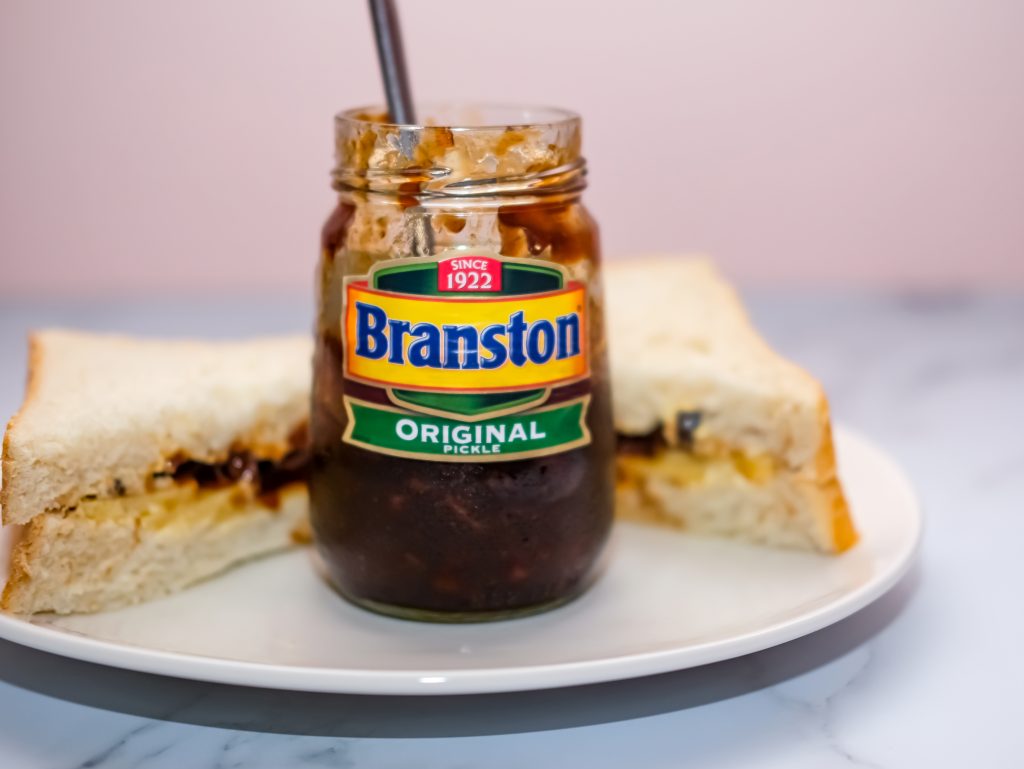 The maker of Branston Pickle has had to drastically hike prices by “unprecedented” amounts in response to soaring manufacturing costs, depicting an open Branston Pickle jar and a cheese sandwich on a white plate