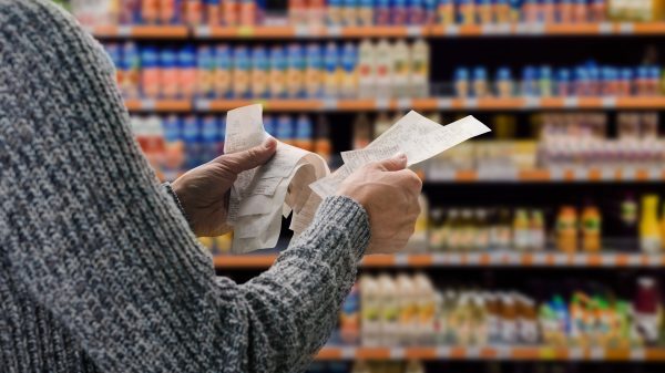 UK food inflation fell to its lowest levels in 17 months in November, but retail bosses are cautioning that this progress has the potential to be undone next year, here depicting someone in a supermarket holding receipts