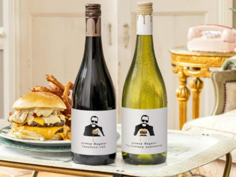 Pernod Ricard UK has unveiled a new wine range designed to complement gourmet fast food and re-engage a younger generation of consumers, here depicting two wine bottles (red and white) in front of a table with a fast food dish of burger and chips