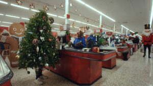 Tesco is encouraging festive spirit this year in its new Christmas advert for 2023, developed by creative agency BBH and entitled 'Become More Christmas', here depicting a still showing a Christmas tree at a festively decorated store