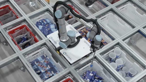 Ocado is doubling the presence of its robotics arms with an aim to boost the online supermarket's speed at packing groceries, here depicting the robotic arms