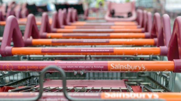 Here depicting the handles of several branded Sainsbury's trolleys